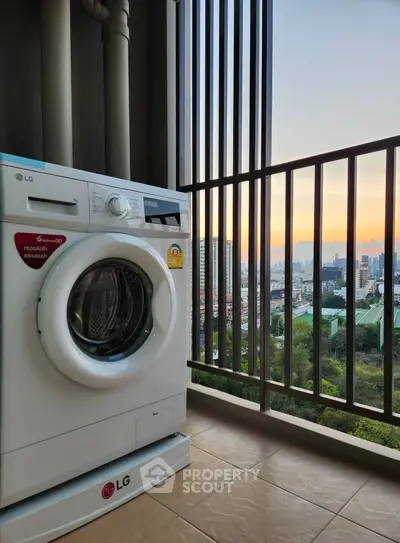 Modern balcony with washing machine and stunning city view at sunset