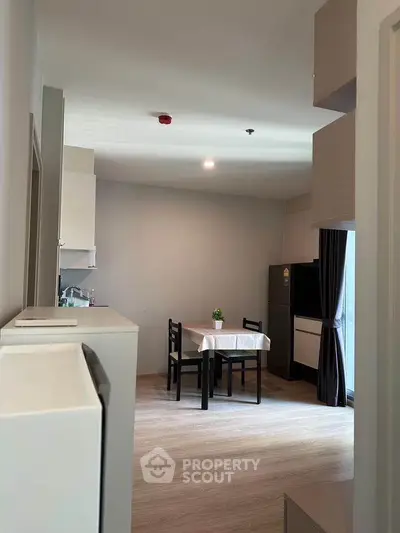 Modern kitchen with dining area and sleek appliances in open layout