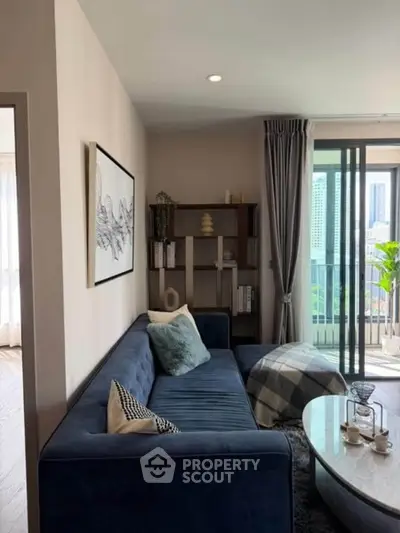 Stylish living room with modern decor and city view balcony access.
