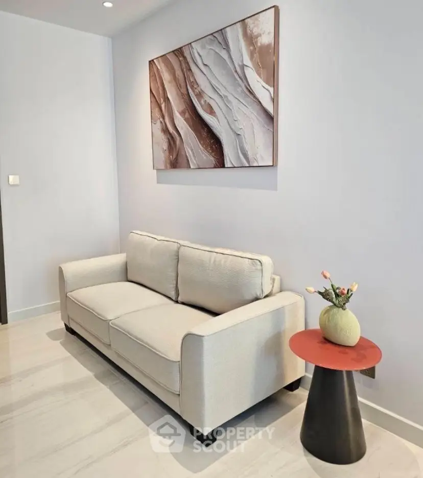 Stylish living room with modern sofa and abstract wall art