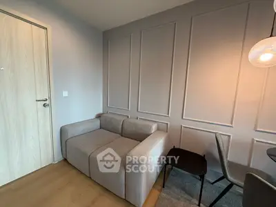 Modern living room with stylish gray sofa and elegant panel wall design.