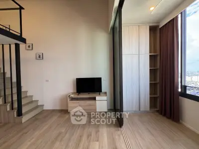 Modern living room with staircase and large window offering city view