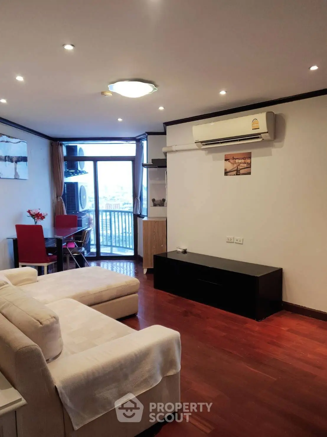 Spacious living room with modern decor and balcony view, perfect for urban living.