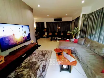 Spacious modern living room with large TV and stylish decor