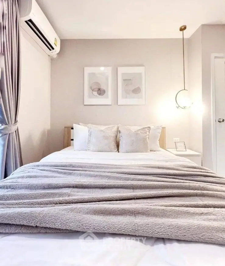 Cozy bedroom with elegant decor and soft lighting, featuring a plush bed and modern artwork.