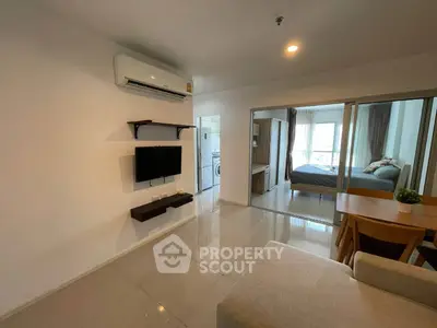 Modern apartment interior with open living room and bedroom view