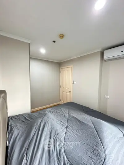 Cozy bedroom with modern air conditioning and neutral decor