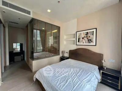 Modern bedroom with stylish decor and large window for natural light