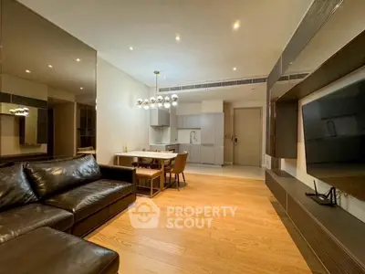 Modern living room with sleek leather sofa and open kitchen layout