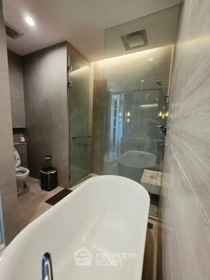 Luxurious modern bathroom with freestanding bathtub and glass shower enclosure