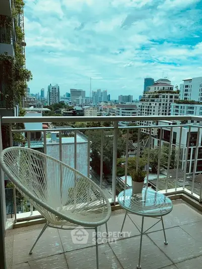 Chic urban balcony with stylish seating and stunning city skyline view.
