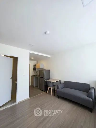 Modern compact living room with kitchenette and minimalist furniture