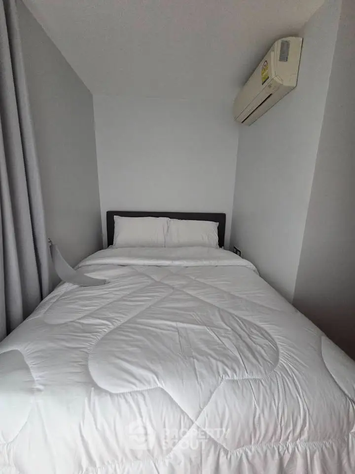 Cozy bedroom with air conditioning and modern decor, perfect for restful nights.