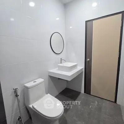 Modern minimalist bathroom with sleek fixtures and contemporary design.