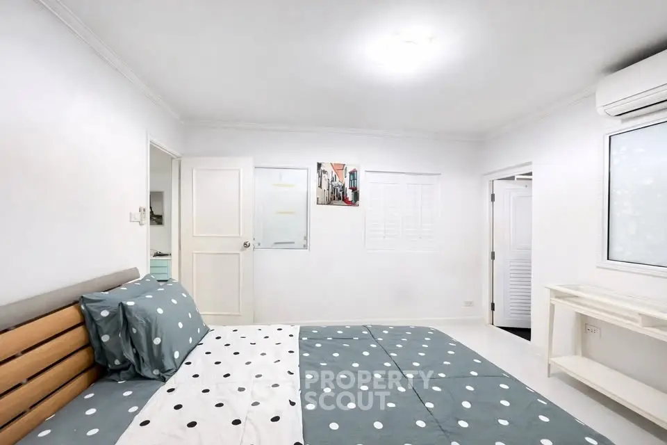 Spacious bedroom with modern decor and ample natural light