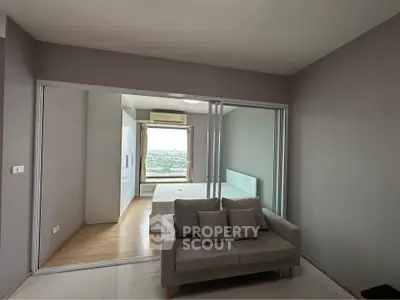 Modern apartment interior with sliding glass doors and scenic view