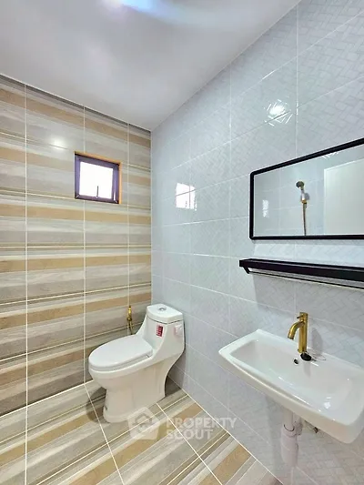 Modern bathroom with stylish tiles and sleek fixtures.