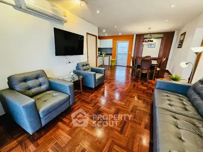 Spacious living room with elegant parquet flooring and modern furniture