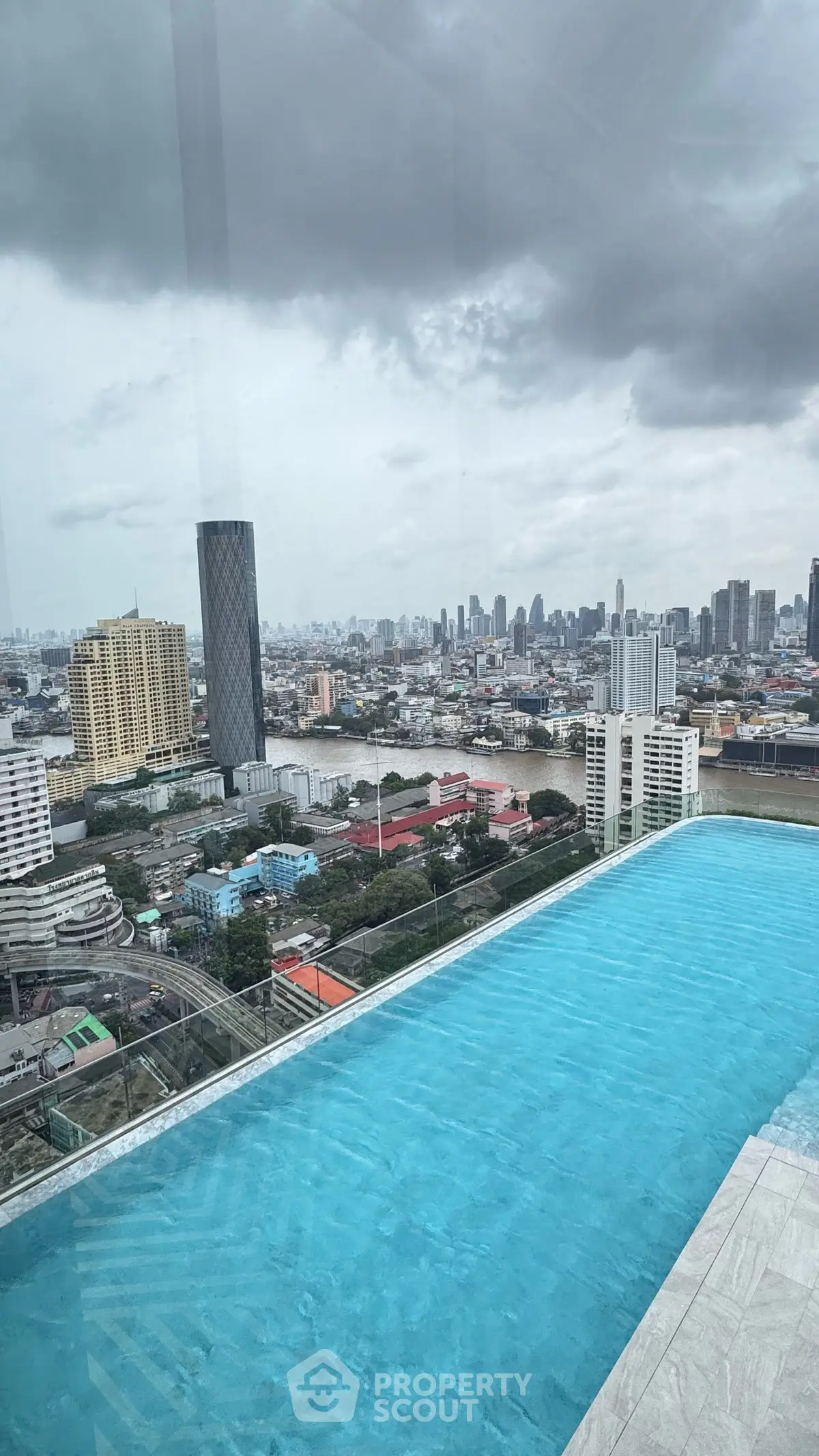 Stunning rooftop pool with panoramic city skyline views, perfect for luxury urban living.