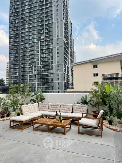 Stylish outdoor patio with elegant seating and cityscape view, perfect for relaxation and entertaining.