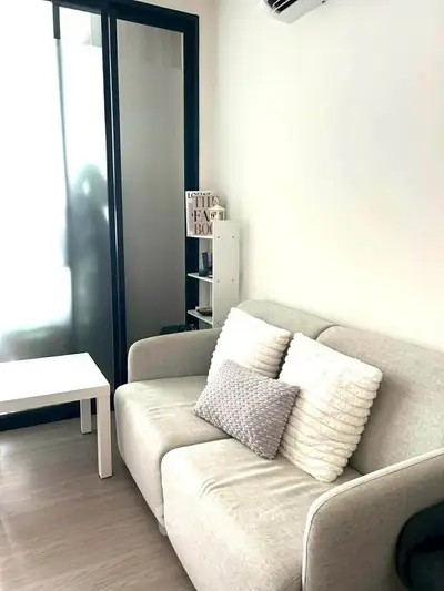 Cozy living room with modern sofa and stylish decor in a bright apartment.