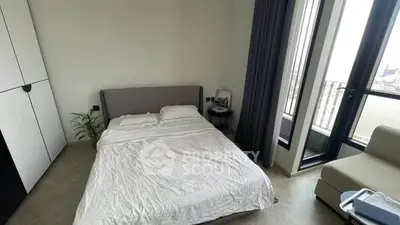 Modern bedroom with balcony view and minimalist decor