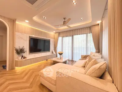 Luxurious living room with elegant decor and large TV, perfect for relaxation.