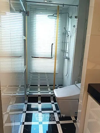 Modern bathroom with sleek shower and stylish black and white flooring