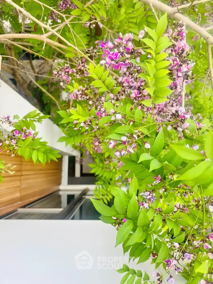 Charming exterior view with lush greenery and modern architectural elements.