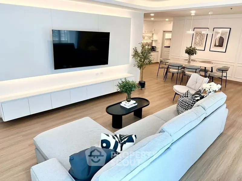 Spacious modern living room with sleek furniture and stylish decor, perfect for contemporary living.