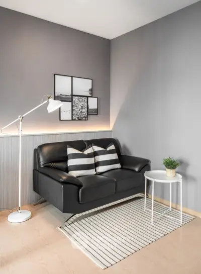 Stylish modern living room with black sofa and minimalist decor