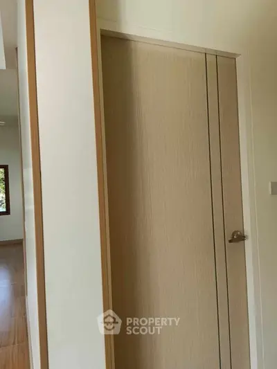 Modern interior with wooden door and hallway in a minimalist home design.