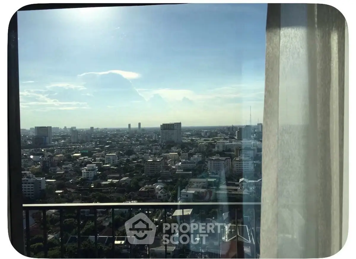 Stunning cityscape view from high-rise apartment window with balcony, perfect for urban living enthusiasts.