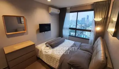 Modern bedroom with city view, featuring stylish decor and natural light, perfect for urban living.