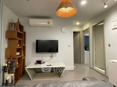 Modern living room with wall-mounted TV and stylish wooden shelving unit.