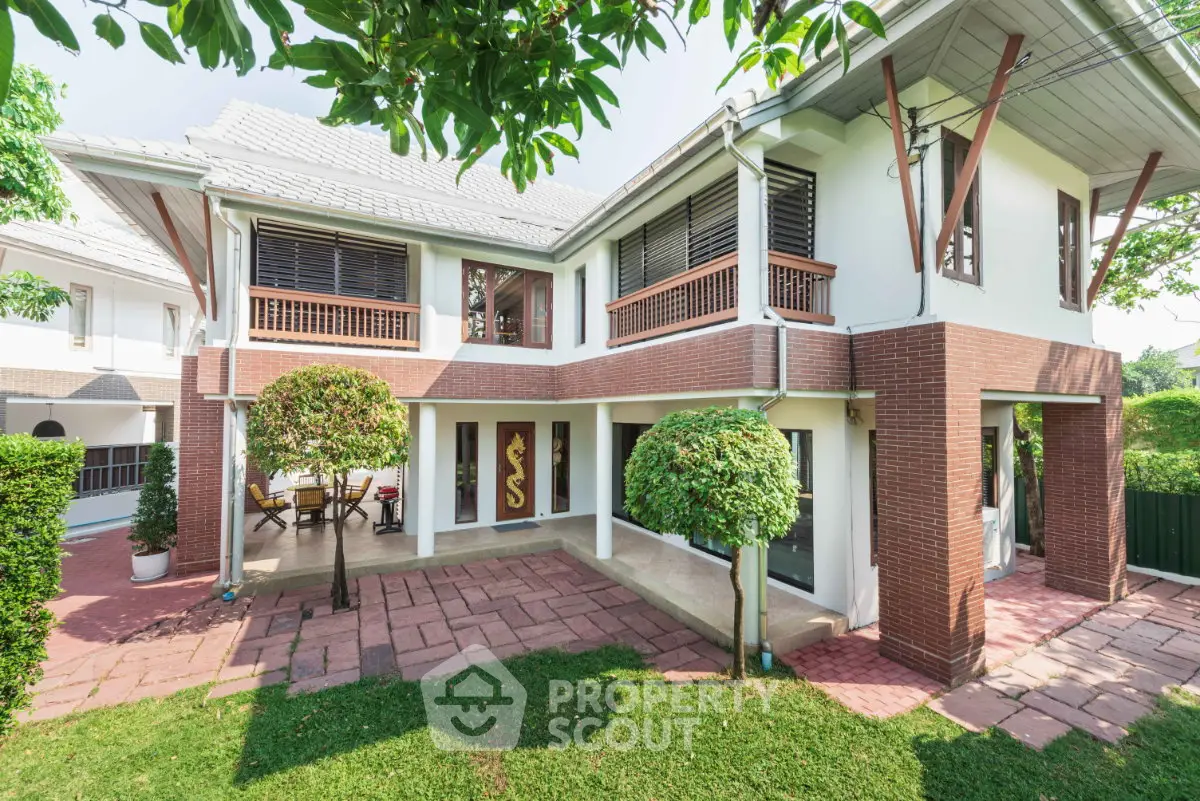 Charming two-story house with lush garden and spacious patio, perfect for family living.