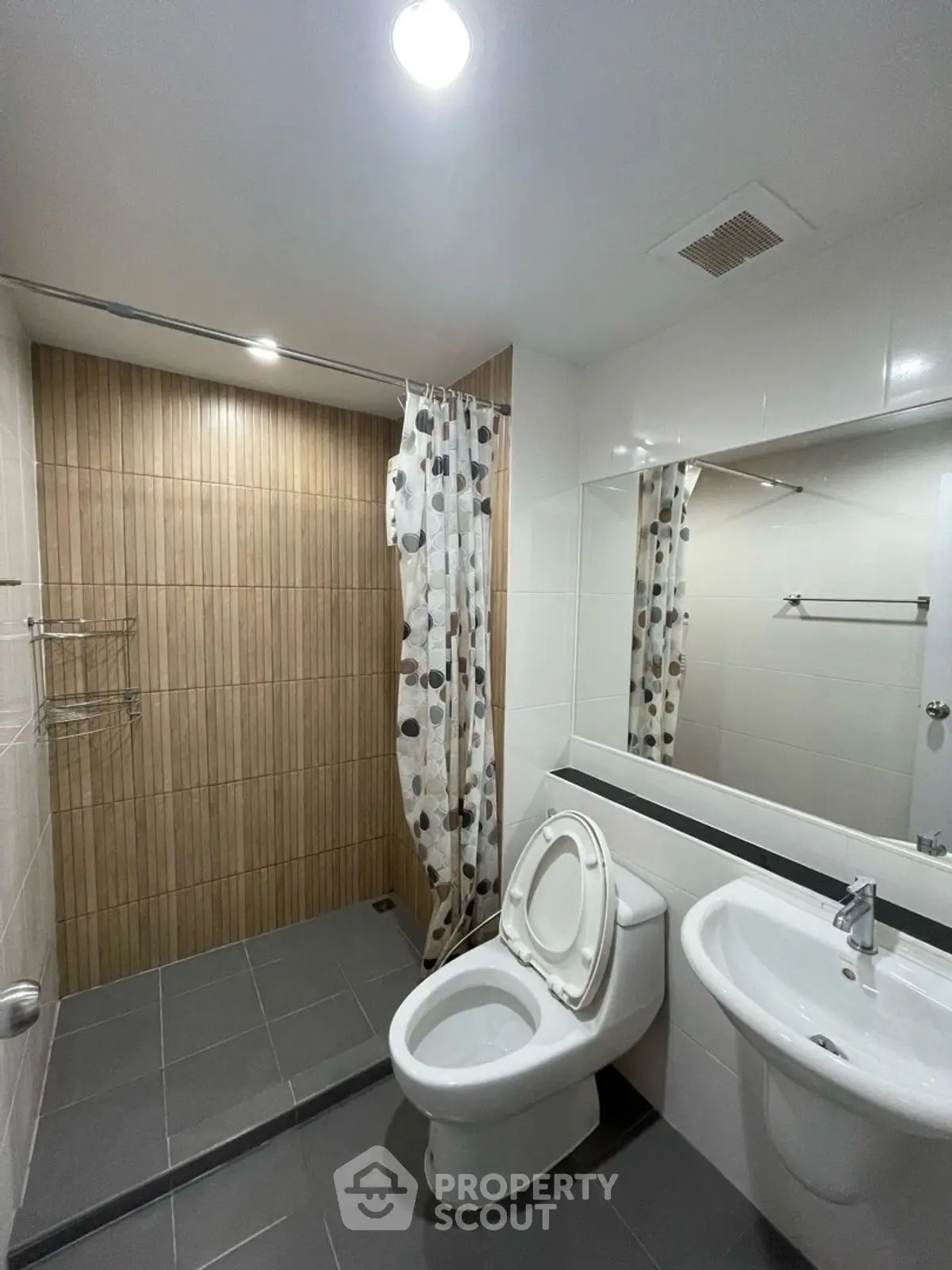 Modern bathroom with sleek fixtures and stylish shower curtain in a contemporary apartment.