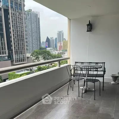 Spacious balcony with elegant furniture and stunning city view