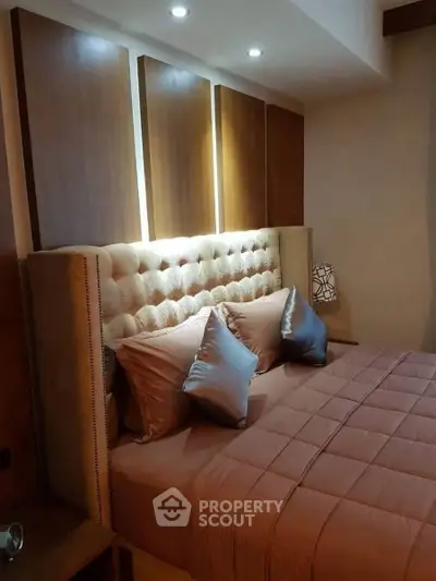 Luxurious bedroom with plush headboard and elegant lighting