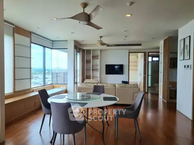 Spacious modern living room with city view, elegant furniture, and wooden flooring.