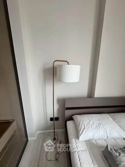 Modern bedroom with sleek floor lamp and minimalist design