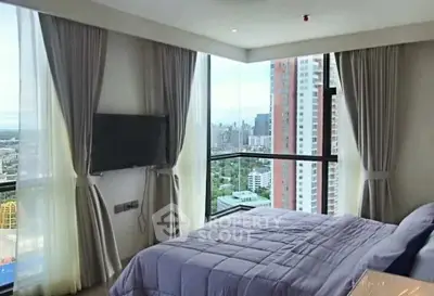Luxurious bedroom with stunning city view and modern decor in high-rise apartment.