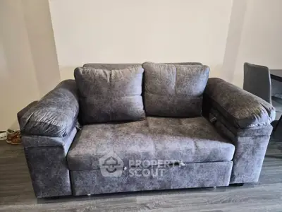 Modern gray sofa in stylish living room with sleek flooring