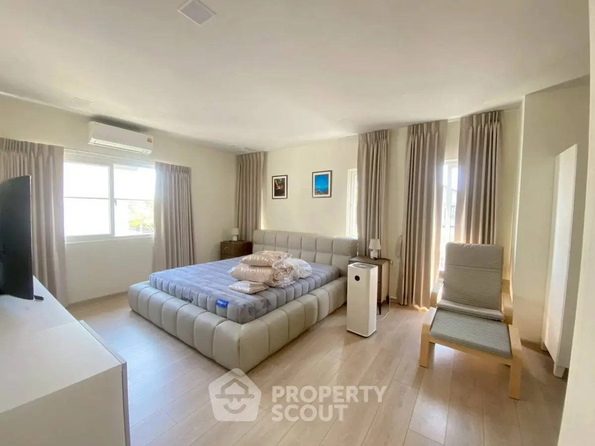 Spacious bedroom with modern decor and natural light