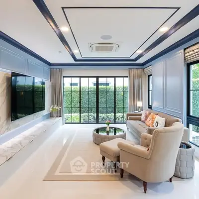 Luxurious living room with elegant decor and large windows overlooking greenery.