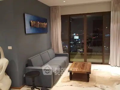 Stylish living room with modern decor and stunning city view from balcony.