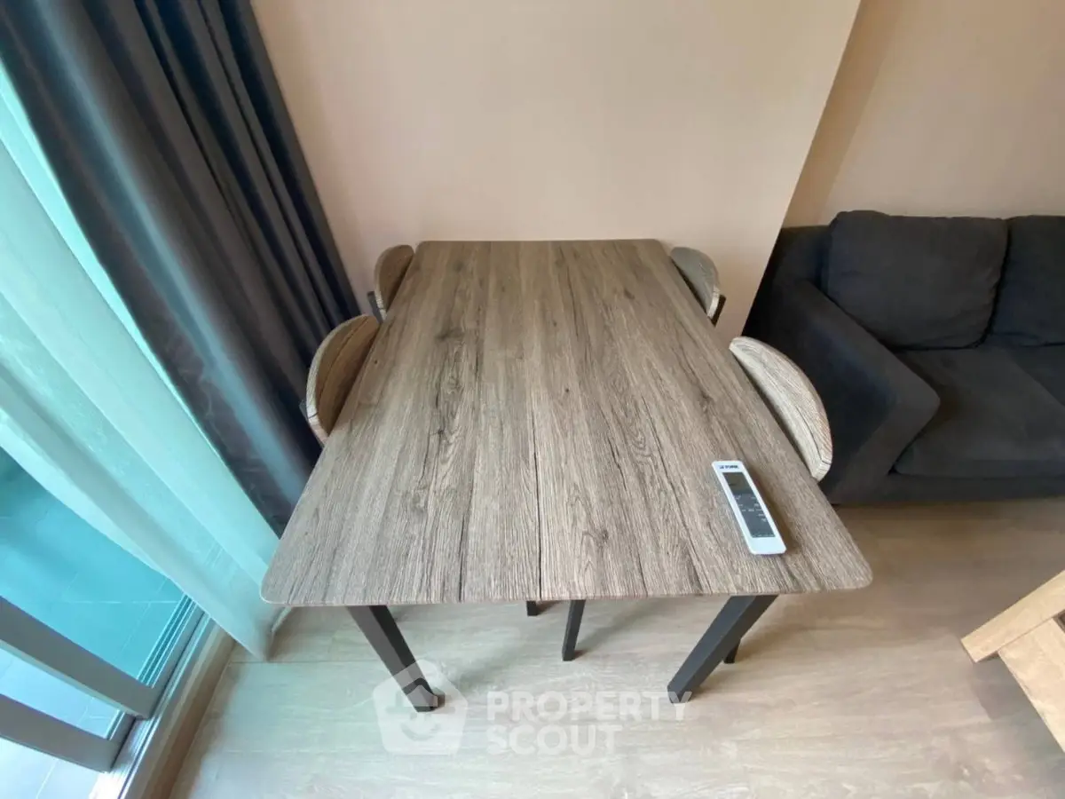 Modern living room with stylish wooden table and cozy seating area, perfect for relaxation and entertaining.