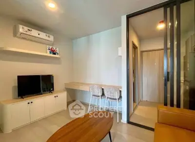 Modern living room with sleek furniture and air conditioning in a stylish apartment.