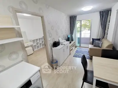 Modern living room with stylish decor and balcony view in a cozy apartment.