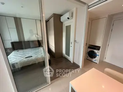 Modern compact apartment with bedroom, air conditioning, and in-unit washer dryer.